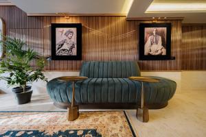 a living room filled with furniture and a painting on the wall at Muze Hotel in Düsseldorf