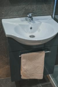a bathroom sink with a towel hanging under it at Il Perale in Caselle in Pittari +43 photos