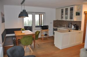 a kitchen and living room with a table and a tableablish at Landhaus Zirben in Bad Kleinkirchheim