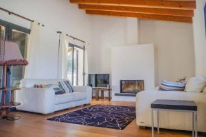 a living room with two white couches and a fireplace at Son Paparra in Montuiri