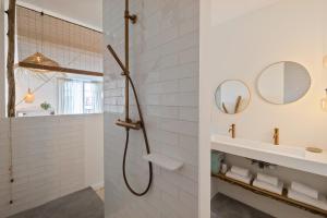 a bathroom with a shower and a sink and mirrors at Libertitu in Bayonne