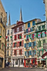 a group of buildings with flags on them at Libertitu in Bayonne