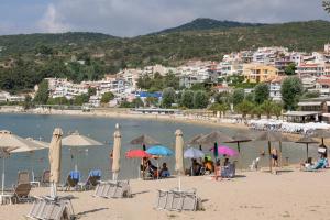 a beach with umbrellas and people on the sand at Lydia's House in Kavála