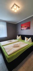 ein Schlafzimmer mit einem großen Bett mit einer grünen Matratze in der Unterkunft Lucys Haus 1 "am Peeneblick" in Peenemünde