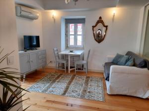 a living room with a couch and a table at Lisbon Castle Apartment in Lisbon