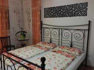 a bedroom with a bed with a floral comforter at Ferienwohnung Viktoria in Bad Kissingen
