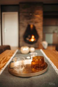 a tray with candles on a table with a fireplace at Le Noir Flohay 30 pers - Malmedy, vue, wellness in Malmedy