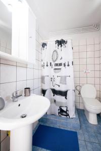 a white bathroom with a sink and a shower curtain at Lydia's House in Kavála +34 photos