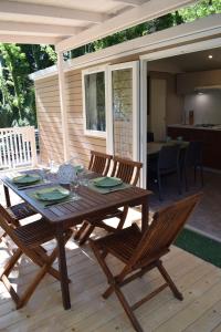 a wooden table and chairs on a deck at Camping Gabicce Monte in Gabicce Mare +15 photos