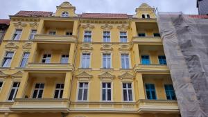 a yellow building with a lot of windows at Kamienica1899 in Szczecin