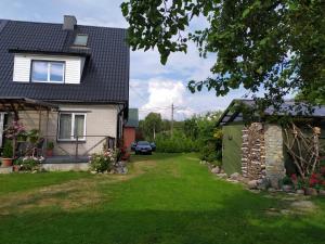 a house with a yard with a green lawn at Ele kodumajutus in Pärnu +16 photos