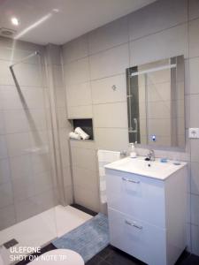 a white bathroom with a sink and a shower at Marrakesh in Los Alcázares