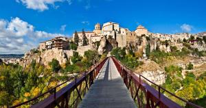 a bridge with a castle on top of a mountain at Biosfera Suites in Palomera