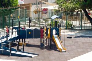 a playground with a slide in a park at Lydia's House in Kavála