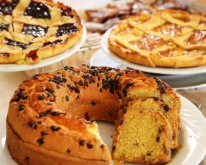 a table with three plates of pastries on plates at Hotel Elisir in Rimini