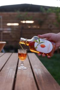 a person pouring a bottle of wine into a glass at Archontiko ''Danae'' in Lefkimmi