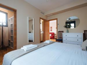 a bedroom with a large white bed with a mirror at Nice Apartment next to Plaza de Armas in Seville