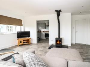 a living room with a couch and a fireplace at Windyridge in Norwich