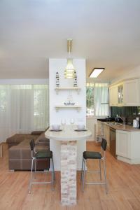 een keuken en een woonkamer met een tafel en stoelen bij Apartments4you Betti in Bat Yam