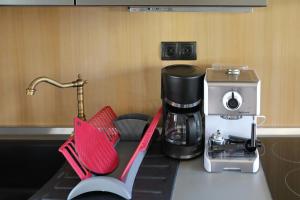 a kitchen counter with a coffee maker and a mixer at Stone Diamond in Zadar