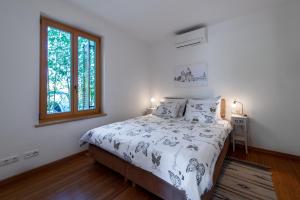 a white bedroom with a bed and a window at Casa Bamboo in Banjole +105 photos