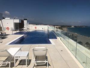 a swimming pool on the roof of a building at Darya Estepona in Estepona