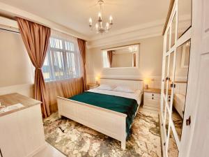 a bedroom with a bed and a dresser at DeLight Apartments in Boryspil