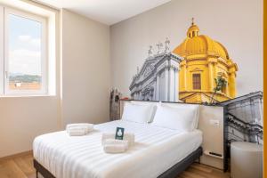 a hotel room with a large bed and a large mirror at B&B Hotel Brescia in Brescia