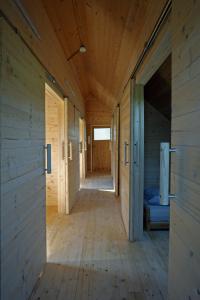 a hallway of a wooden cabin with a bed in it at Centris in Feistritz im Rosental
