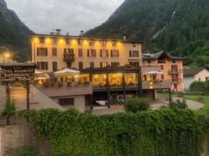 a large building in front of a mountain at Hotel Pedretti in Branzi
