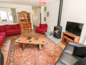 a living room with a table and a fireplace at 1 The Warren in Narberth