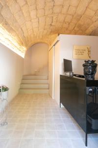 an office with a wooden ceiling and stairs at Moronero in Ragusa