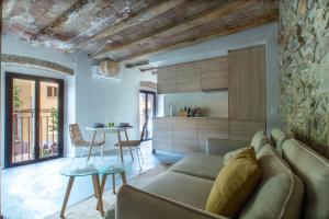 a living room with a couch and a table at Bruma Boutique Apartment in Girona