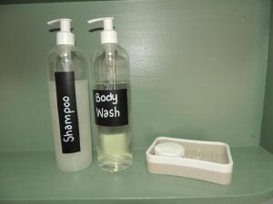 two bottles of soap and a container on a counter at Stone Haven at Nieu Bethesda in Nieu-Bethesda