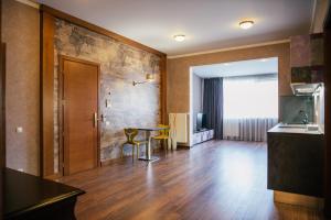a living room with a table and a kitchen at D31 Hotel in Odesa