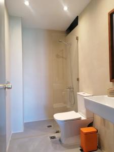 a bathroom with a shower and a toilet and a sink at Endless Summer Pool Flat in Ixia