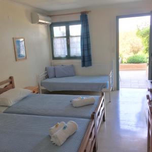 A bed or beds in a room at Galini Studios and Apartments