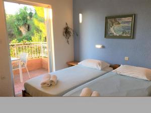 A bed or beds in a room at Galini Studios and Apartments