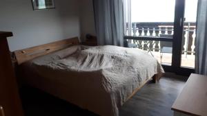 a bedroom with a bed and a window with a view at Ferienhaus Rhönblick in Bischofsheim an der Rhön