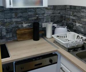a kitchen with a counter top with a dish drying rack at Ferienhaus Rhönblick in Bischofsheim an der Rhön +10 photos