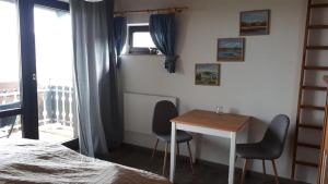 a bedroom with a table and two chairs and a bed at Ferienhaus Rhönblick in Bischofsheim an der Rhön
