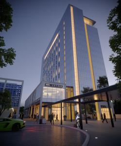 a tall building with a car in front of it at Hotel La Tour in Milton Keynes