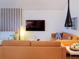 a living room with a couch and a table at 6 person holiday home in Slagelse in Slagelse