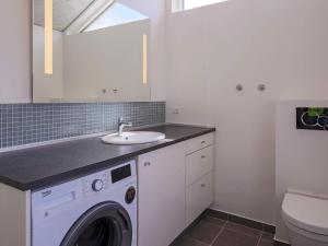 a bathroom with a washing machine and a sink at 6 person holiday home in Slagelse in Slagelse