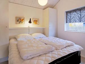 a large bed in a bedroom with a window at 6 person holiday home in Slagelse in Slagelse