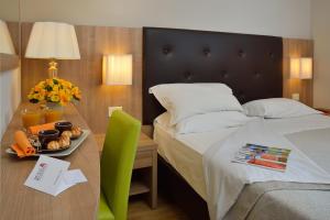 Кровать или кровати в номере Hotel Rossini