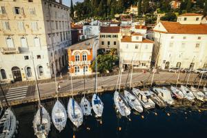 a group of boats docked in a harbor with buildings at Apartment Park Piran in Piran