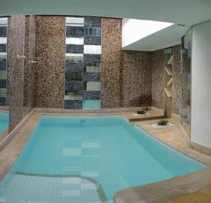 a large swimming pool in a building at Motel Colorado (Adult Only) in Brasília