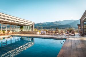 a large swimming pool with a balcony overlooking a city at Cerdanya EcoResort in Prullans