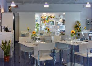 a restaurant with tables and chairs with sunflowers on them at Aurea Hotel in Tortoreto Lido